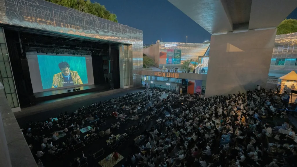 Посетители кинофестиваля смотрят кино на большом экране