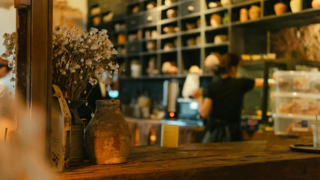 Бармен за стойкой, цветы, бутылки вина