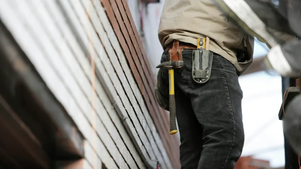 Рабочий с инструментами в кармане брюк